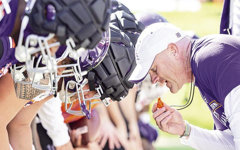 Head coach Blaine McCorkle leans toward his team to start a drill Monday. Photo by Chris Reich/NSU Photographic Services