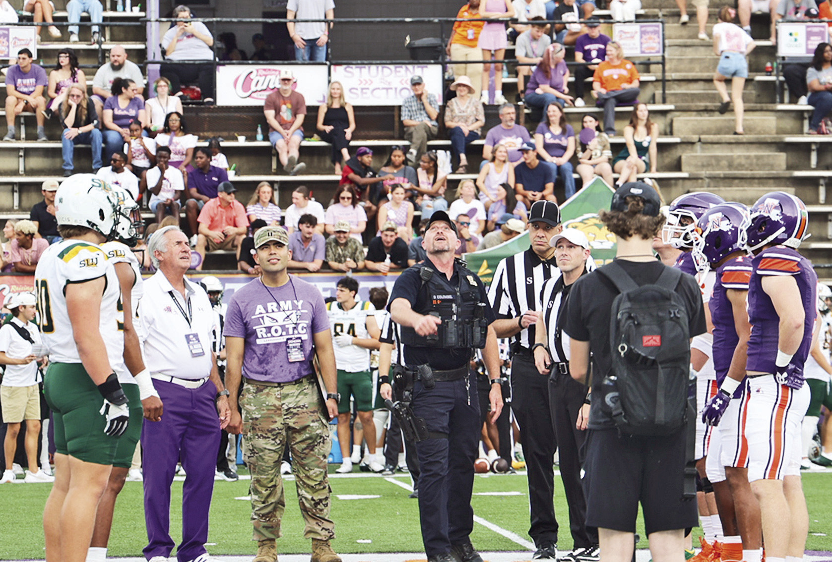 Staff Sergeant (Ssgt.) Retired, Donterry Colombel, center, did the coin toss prior to NSU’s football game against Southeastern Sept. 26. In addition to players and game officials, he was accompanied by NSU President James Genovese and Capt. Armando Lopez, head of NSU’s Department of Military Science.