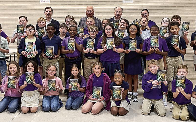 Rotarians Mike Newton, Tommy Caldwell and Joe Henry delivered books to 4th graders at Provencal.