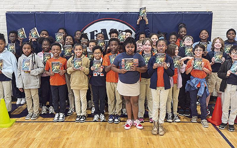 Lee Waskom distributed books to Natchitoches Magnet.