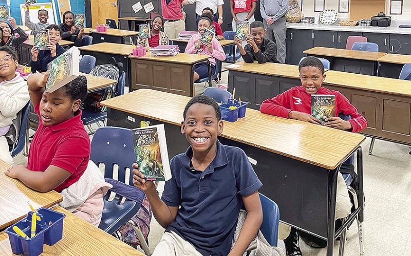 Rotarians Louie Bernard, John Ackel and Richard Guidroz delivered books to Weaver Elementary.