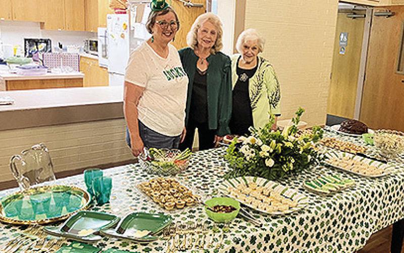 Hostesses for the March meeting of Lesche are, from left, Mary Striegel, Dianne Alexander and Barbara Gillis.