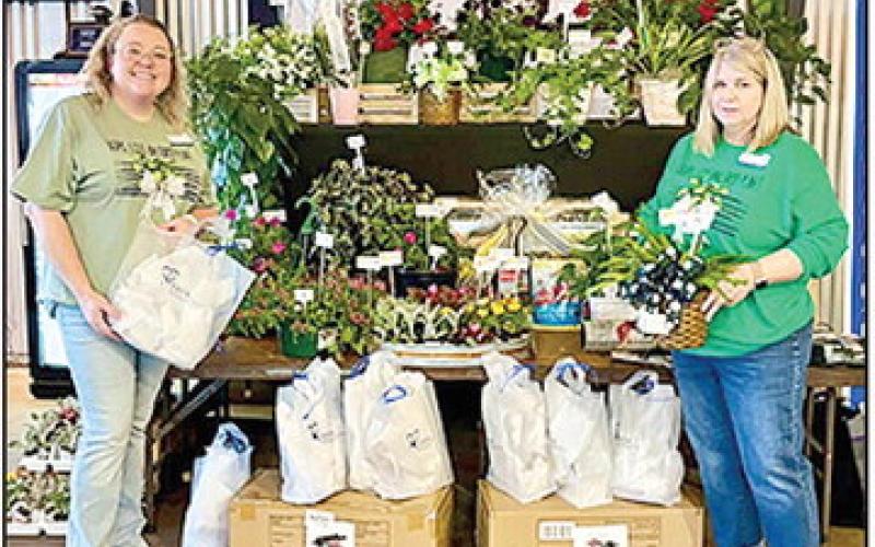 CASA of Central Louisiana Diretor Emily Dahl and CASA Program Support Specialist Brenda McCain show the Plant Bingo prizes.