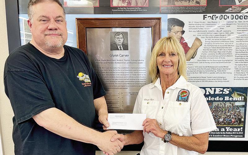 Curt Carver of Toledo Town &amp;amp; Tackle presents a check to TBLA President Ginger Rice to help fund the Glynn Carver Memorial Scholarship.