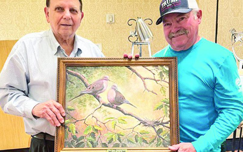 Wildlife Artist Don Edwards presents Larry Rice of Many with his canvas giclee’ “New Home – Mourning Dove” as the successful bidder on this piece.