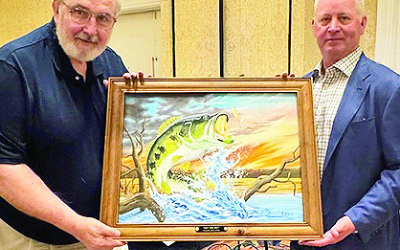 Stacy Floyd of Jena was the successful bidder on “Get the Net!” by Artist Larry Riales, pictured at left.