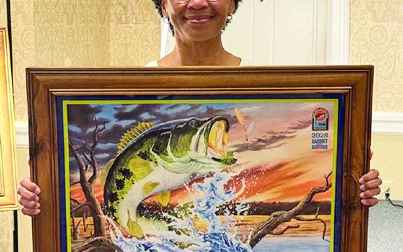 Georgia Craven of Many was the successful bidder on the first signed and numbered print by Artist Larry Riales.