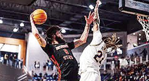 Addison Patterson (left) attacks the rim and McNeese’s Christian Shumate. Credit: Southland Conference