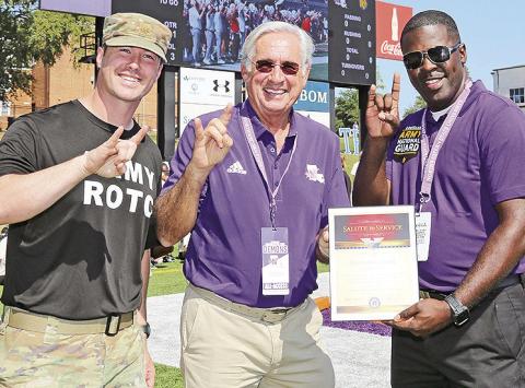 Staff Sgt. Brandon Bullock of Shreveport was honorary captain for Northwestern State University’s Oct. 12 football game. From left are Assistant Professor of Military Science Major Kegan Davis, NSU President James Genovese and Bullock.