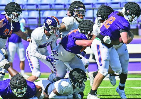 Matthew Broad runs through the Northwestern State defense during Saturday’s scrimmage. Photo by Gary Hardamon/NSU Photographic Services