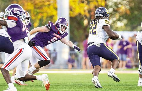 NSU’s Danny Sears (purple - 9) extends for a tackle against East Texas A&amp;M’s JaiSean McMillian (white – 22) Photo by Chris Reich, NSU Photographic Services