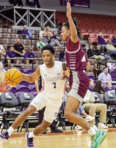 Northwestern State’s Love Bettis (7) drives the baseline against Dallas Christian’s Isaiah Mitchell. Photo by Chris Reich/NSU Photographic Services