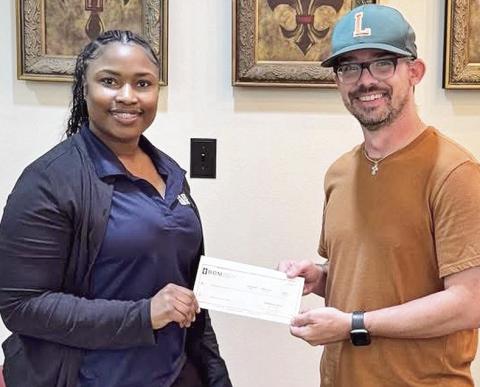 BOM made a donation to the Lakeview High School softball program. Pictured from the left are BOM’s Shonterika Payton and LHS Head Coach Blake Dodson.