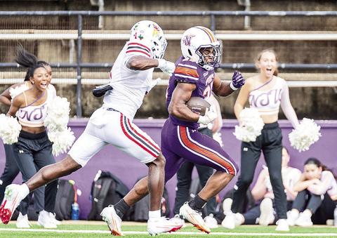 Jeremiah James (purple) rushes towards the end zone on one of NSU’s eight explosive plays as Lamar’s Kristian Pugh (white) gives chase. Photo by Chris Reich, NSU Photographic Services