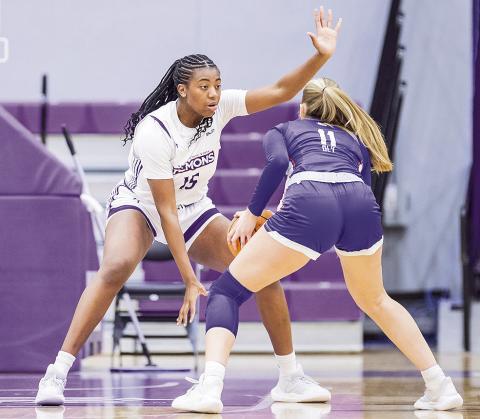 Clarence Djuela (15-white) sets her defensive stance. Photo by Chris Reich, NSU Photographic Services