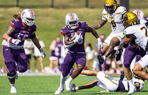 Northwestern State’s Zay Davis (center) cuts upfield during the Demons’ Oct. 12 game against Texas A&amp;M-Commerce. Photo by Chris Reich/NSU Photographic Services