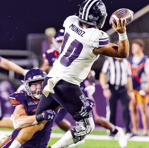 Blake Gotcher sacks Weber State quarterback Richie Munoz on Sept. 21. Photo by Chris Reich/NSU Photographic Services