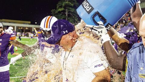 Players douse Northwestern State head coach Blaine McCorkle with orange Powerade following Thursday’s win against Alcorn State. Photo by Chris Reich/NSU Photographic Services