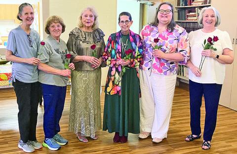 Receiving red roses were, from left, Mary Squyres, Susan Massia, Dianne Alexander, Gilen Norwood, Donna Baker and Janine Storrs after the installation of officers.