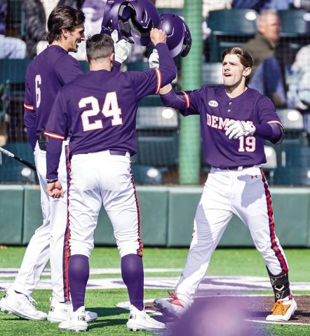 Rocco Gump (left) and Reese Lipoma (24) congratulate Samuel Stephenson after Stephenson homered last weekend’s series finale against Central Arkansas. Photo by Chris Reich/NSU Photographic Services