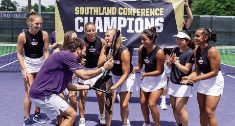Head coach Marcos Morelli celebrates with the Lady Demons as they clinched the regular season SLC title on Monday following a 4-3 victory over Southeastern. Photo by Chris Reich, NSU Photographic Services