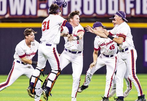 Clay Jung (center) is mobbed by teammates after Jung’s RBI double gave Northwestern State a 10-inning win against Lamar on Friday night. Photo by Chris Reich/NSU Photographic Services