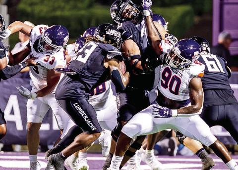 Chancellor Owens (90) fends off the SFA offensive line Saturday night. Photo by Chris Reich/NSU Photographic Services