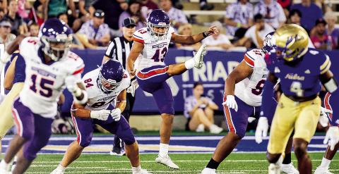 Reed Honshtein (center) had a key fake punt conversion Saturday at Nicholls. Photo by Chris Reich/NSU Photographic Services