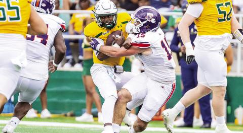 Northwestern State’s Barrett Newman (15) tackles Southeastern Louisiana quarterback Kyle Lowe during Saturday’s game. Photo by Chris Reich/NSU Photographic Services