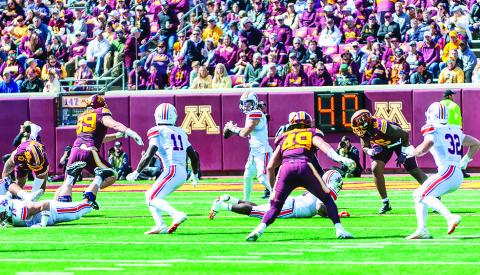 Northwestern State quarterback Abram Johnston (center) throws a pass during the Demons’ loss to Minnesota. Photo by Brad Welborn/ NSU Sports Information