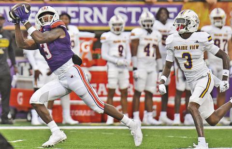Myles Kitt-Denton (left) pulls in a 71-yard touchdown catch against Prairie View A&amp;M on Sept. 7. Photo by Chris Reich/NSU Photographic Services