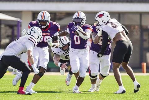 Myion Hicks (0-purple) plows ahead against the UIW defense. Photo by Chris Reich, NSU Photographic Services