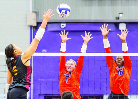 NSU’s Julia Whitfield (1) and Deja Benjamin go for the block. Photo by Chris Reich, NSU Photographic services
