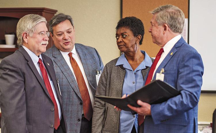 Victims Assistance Coordinator Alice Hardison looks on as Special Counsels Clifford R. Spider and Stephen Mansour discuss strategy with DistrictAttorney Billy Joe Harrington in opposing clemency for death row inmate Tracy Lee.