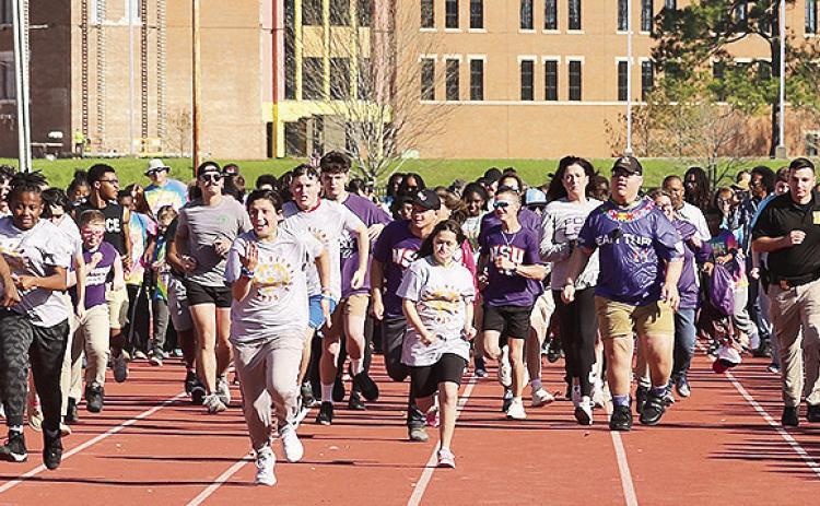 Area athletes opened the Special Olympics Red River Games with the traditional torch run.
