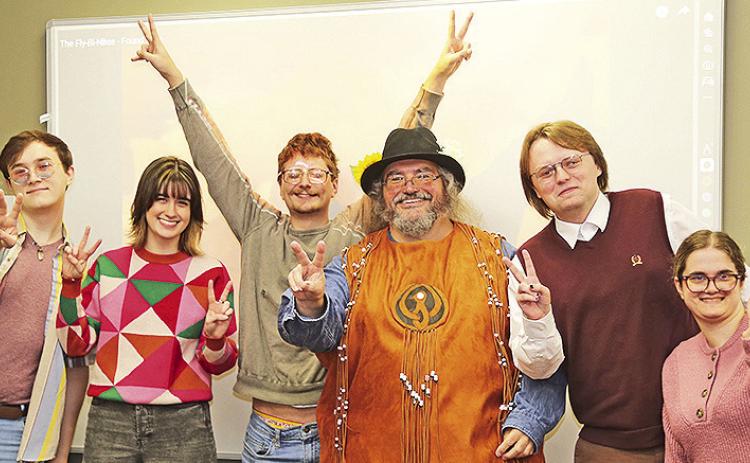 To give his students a taste of hippie counterculture, Dr. Charles Pellegrin worked with costume designer Elizabeth Lofton to recreate a vest worn by musician Terry Kirkman on the Ed Sullivan Show in 1969. From left are Cameron Remry, Katie Grace Rian, Mason Nugent, Pellegrin, Ezra Jett and Grace Lemoine.