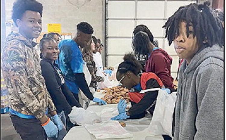 The seventh grade JAG members volunteer at food bank.