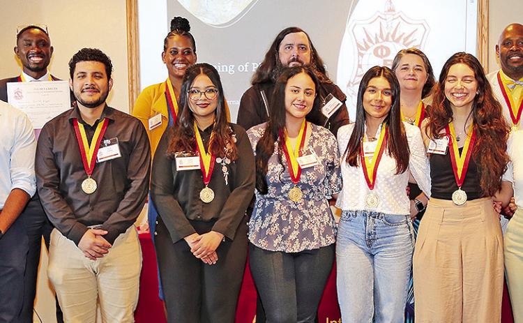 The NSU chapter of Phi Beta Delta honor society for international scholarship welcomed 16 new members. On the front row from left are Chapter President Dr. Weiwen Liao, Juan Sebastian Castilla, Juan Padilla, Zaiba Daud, Gabriela Forero Salcedo, Andrea Fernandez Garcia, Maria Alzate Castaneda, Lia Portillo and Valentina Herazo-Alvarez. On the back row are Dr. Erick Kigen, Janiel Moore, Shea Montgomery, Dr. Francene Lemoine, Dr. Charles King and Dr. Charles Pellegrin.