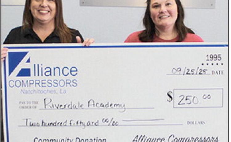 Alliance Compressors makes a $250 donation to Riverdale Academy’s 10th annual Rebel Fest. From left are Alliance HR Manager Rachel Barlow and Leslie Murray from Riverdale Academy.