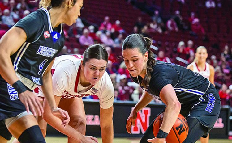Carla Celaya (right) grabs a loose ball in game against Nebraska.