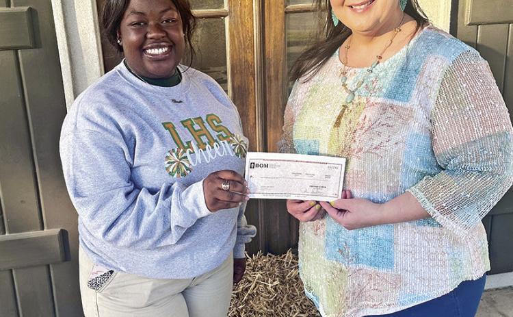 BOM is a sponsor of the Lakeview High School Cheer Team. Pictured from the left are Ariel Joseph and BOM’s Shannon Frame.