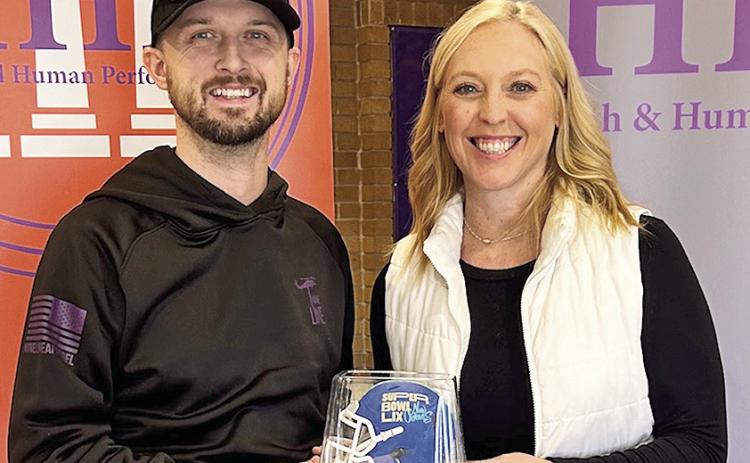 Justin Lee was named a Teammate MVP for his volunteer work at Super Bowl LIX, earning a special commemorative helmet, which was presented by Dr. Haley Blount, the professor who nominated him for the honor.