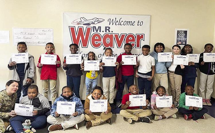 Weaver Elementary Terrific Kids for March are presented certificates. On front row from left are Kiwanian Tiffany Gourdon and third graders Kayden Calvin, Gary Marsh, Bryceston Thomas, Brandon Garrett, Asia Aaron and Calvin Duncantell. Not pictured are Keith Brisker and I’sys McZeal. On back row are fourth graders Terrance Besant, Randall Reyna, Ja’Qulen Mitchell, Arianna Jackson, Arayiah Slate, Marcelo Horton, Cason Medlock, Imani Paige, Aubreigh Dubois, Justice Harts and Zyrielle Slate.