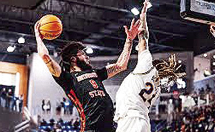 Addison Patterson (left) attacks the rim and McNeese’s Christian Shumate. Credit: Southland Conference