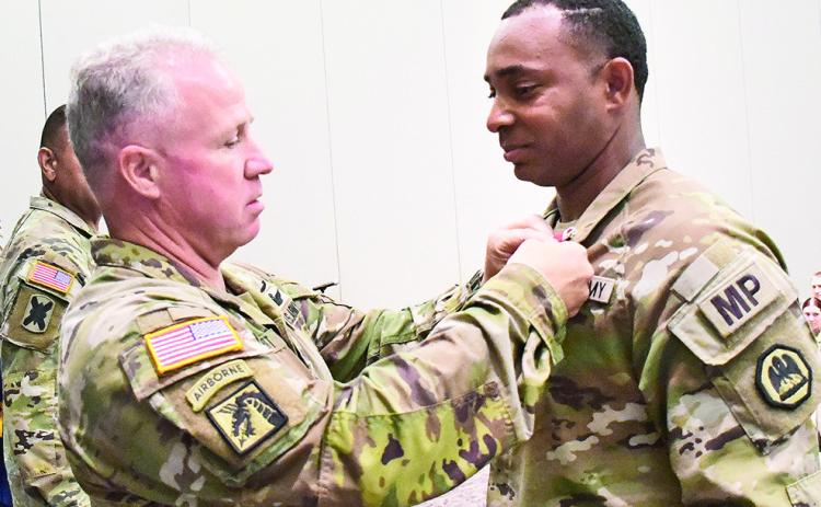 Brig. Gen. John Plunkett, special assistant to the adjutant general of Louisiana, pins the Louisiana National Guard War Cross medal on Capt. Albert E. Tuiel Jr., 39th Military Police Company commander, during a post deployment awards ceremony held at the Shreveport Convention Center in Shreveport on August 3, 2025.