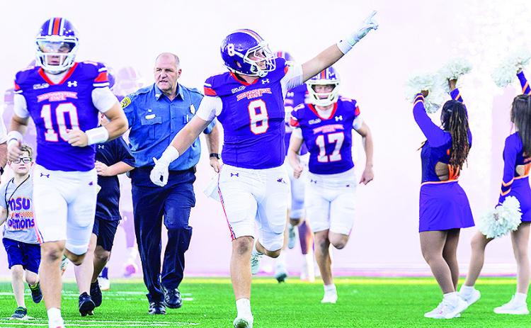 Luke Carter, #9, leads the team onto the field during pregame ceremony. Credit: Chris Reich, NSU Photographic Services