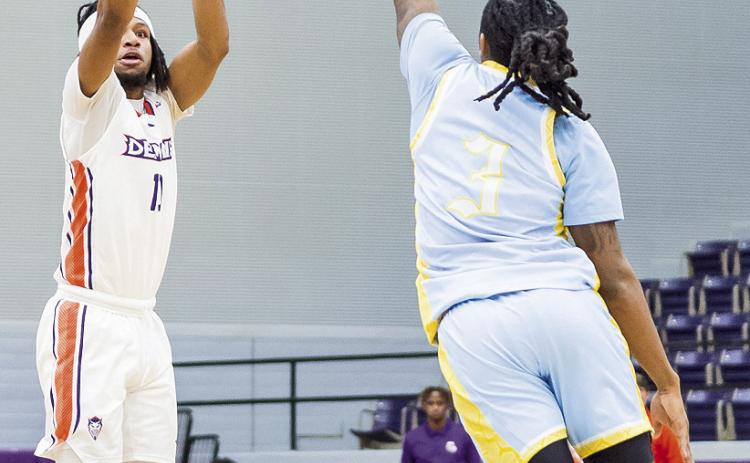 Cliff Davis (left) sank a schoolrecord 10 3-pointers in the Demons’ win against SUNO on Tuesday night