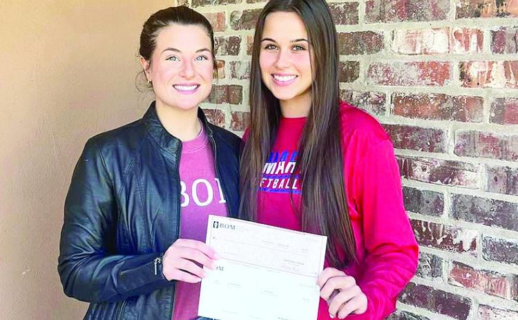 BOM is a supporter of the St. Mary’s Catholic School softball program. Pictured from left are BOM’s Mary Scruggs and Brooklyn Townson.
