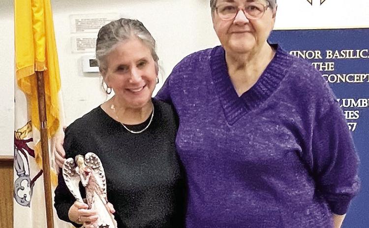 Kathleen Hicks, regent for The Catholic Daughters of the Americas Court Regina Pacis 1372, presented the Catholic Daughter of the Year award to Ann Taylor, left.