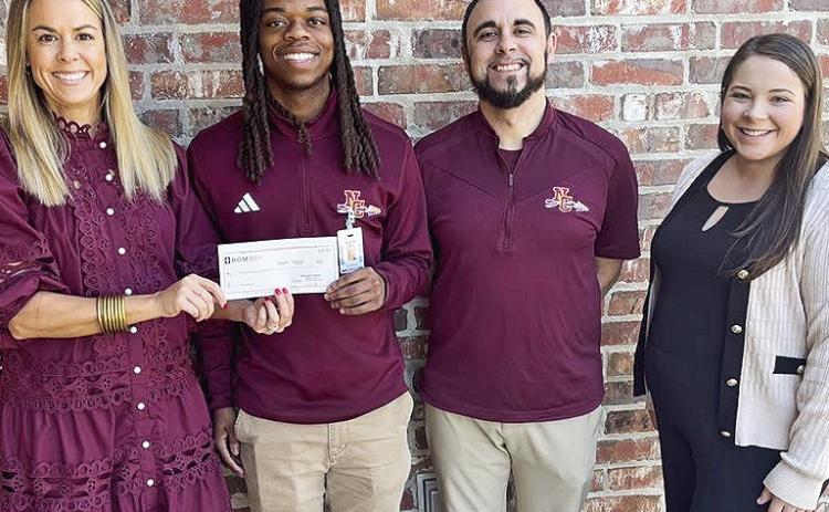 BOM is continuing support of the Natchitoches Central High School boys and girls basketball gym sign fundraiser. From left are BOM’s Carrie Beth Hough, NCHS Senior #10 Jaden Braden, NCHS head boys’ Coach Kolton Sepulvadoand BOM’s Alyssa Austin.